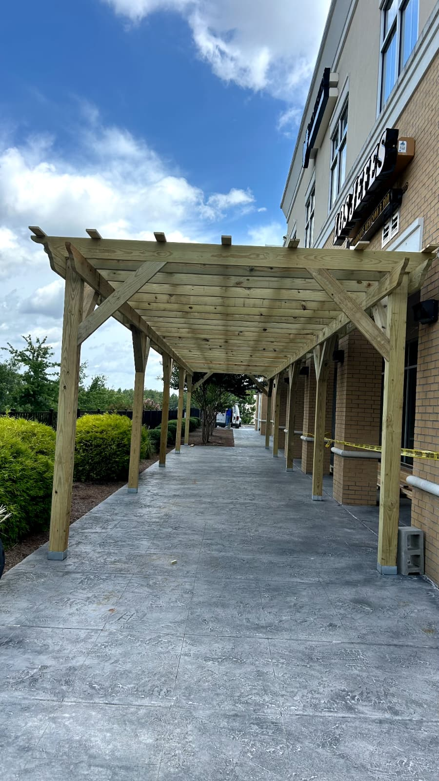 Wooden pergola built over the same walkway after completion